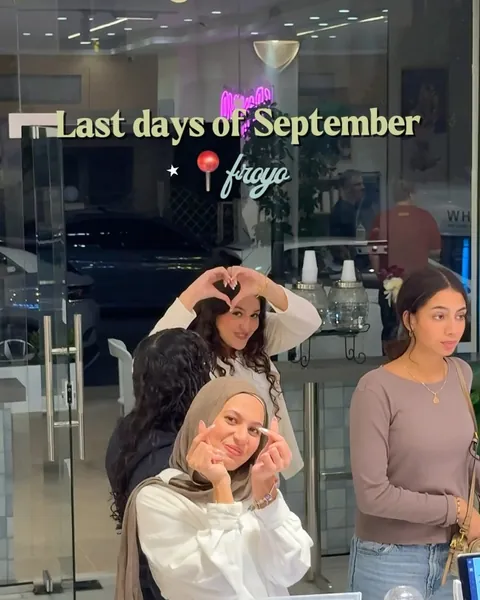 Friends making heart shapes at the Froyo counter, last days of September